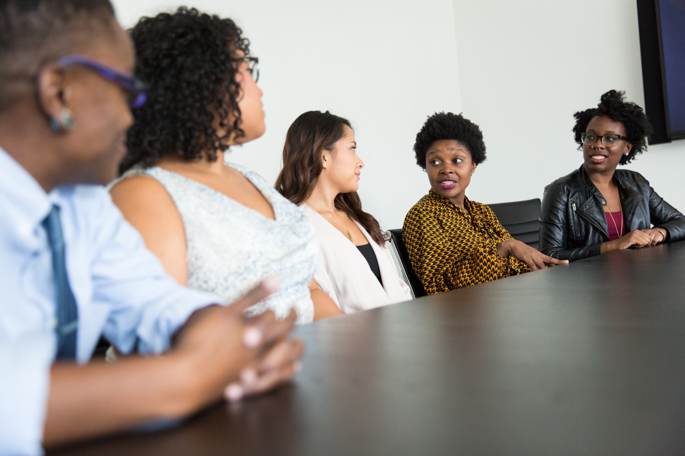 Colleagues in an engaged discussion around a boardroom table