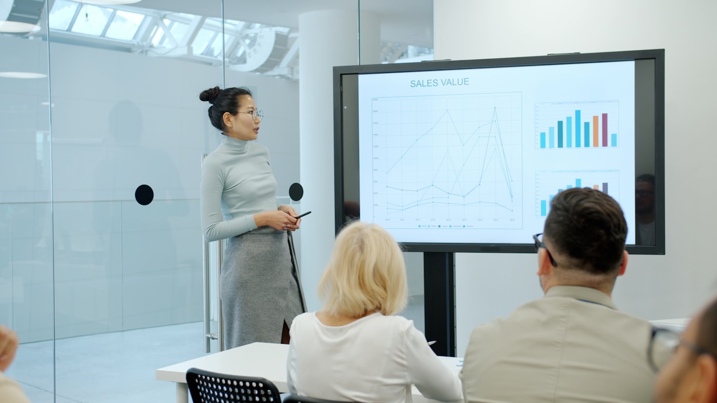 A presenter walking an audience through workplace wellbeing data